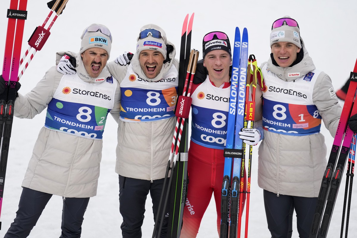 Jonas Baumann, Jason Rueesch, Valerio Grond, and Cyril Faehndrich, from left, of Switzerland, celebrate after winning the silver medal in the cross-country men's relay 4X7.5 Km at the Nordic Worl ...