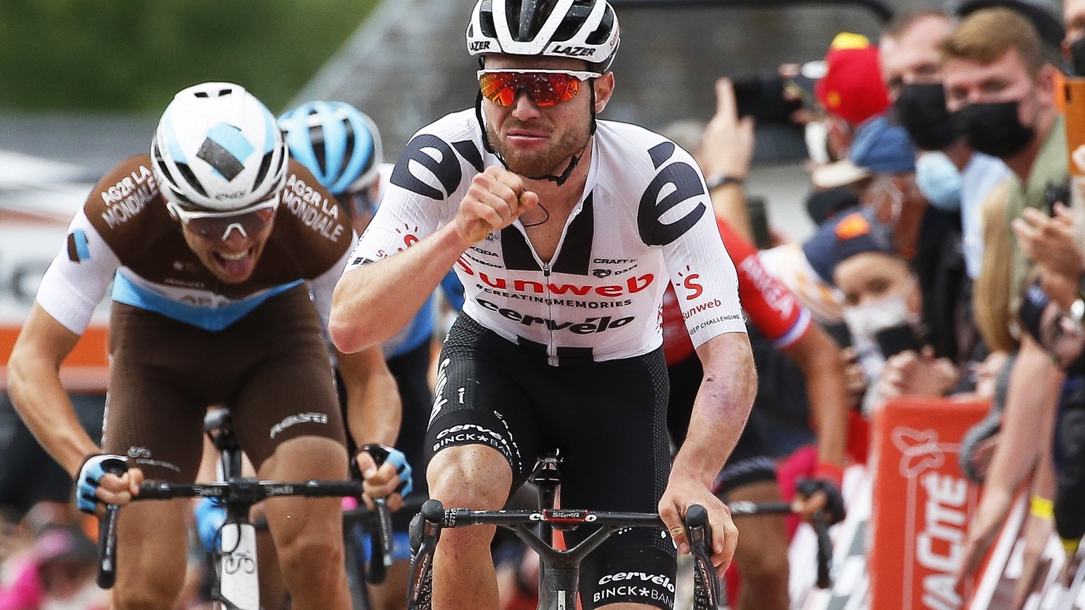 epa08708904 Swiss rider Marc Hirschi (C) of Team Sunweb celebrates while crossing the finish line to win the 84th edition of the Fleche Wallonne one day cycling race over 202km from Herve to Huy, Belg ...