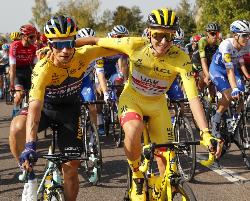 Slovenia&#039;s Primoz Roglic, left, who lost his overall leader&#039;s yellow jersey to Slovenia&#039;s Tadej Pogacar, right, in Saturday&#039;s time trial, gets a hug during the twenty-first and las ...