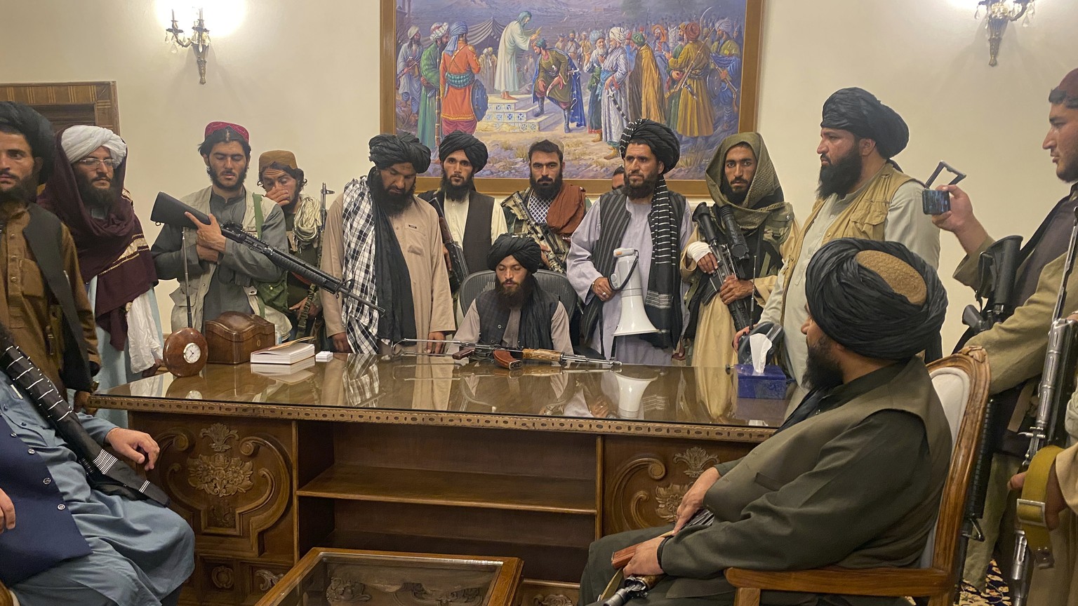FILE - In this Aug. 15, 2021, file photo, Taliban fighters take control of the Afghan presidential palace in Kabul, Afghanistan, after President Ashraf Ghani fled the country. On the eve of the annive ...