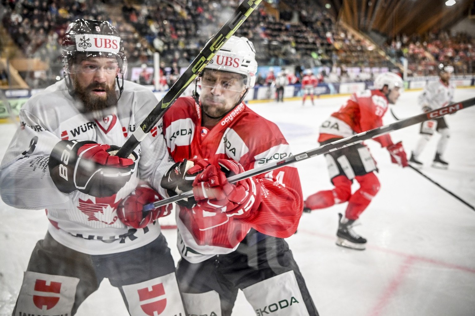 Canada&#039;s Jordie Benn against Pardubice&#039;s Patrik Poulicek during the game between HC Dynamo Pardubice from Czech Republic and Team Canada at the 95th Spengler Cup ice hockey tournament in Dav ...