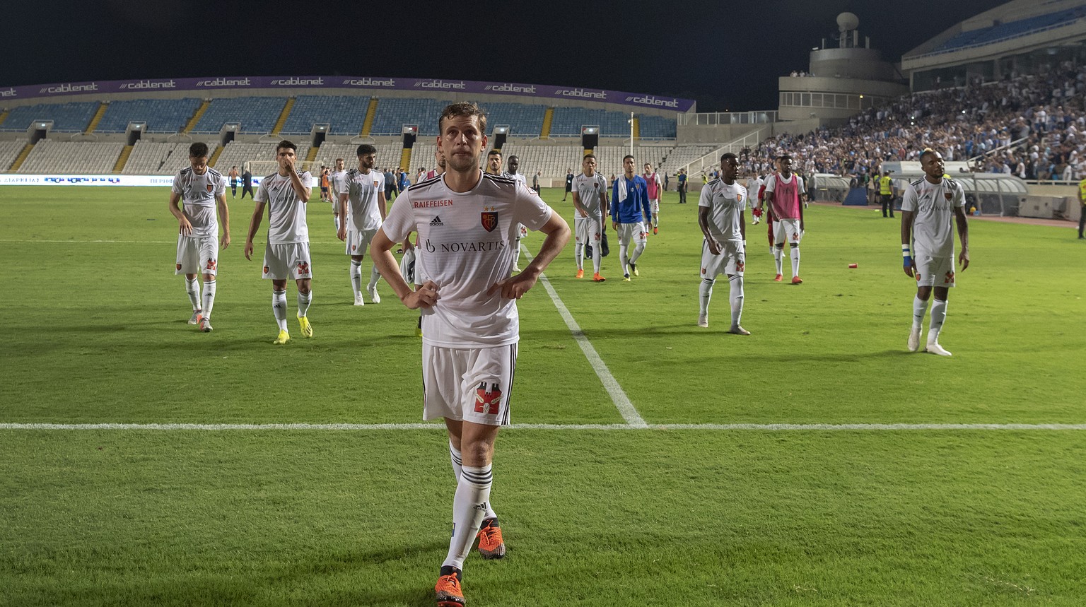 Basel&#039;s disappointed players with captain Fabian Frei, front, leave the pitch after the UEFA Europa League play-off second leg match between Cyprus&#039; Apollon Limassol FC and Switzerland&#039; ...