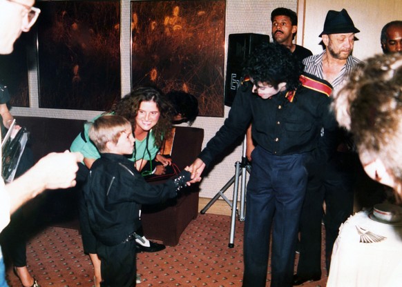 This image released by HBO shows a young Wade Robson shaking hands with pop icon Michael Jackson in 1987, in a scene from the documentary &quot;Leaving Neverland.&quot; The unsparing documentary about ...