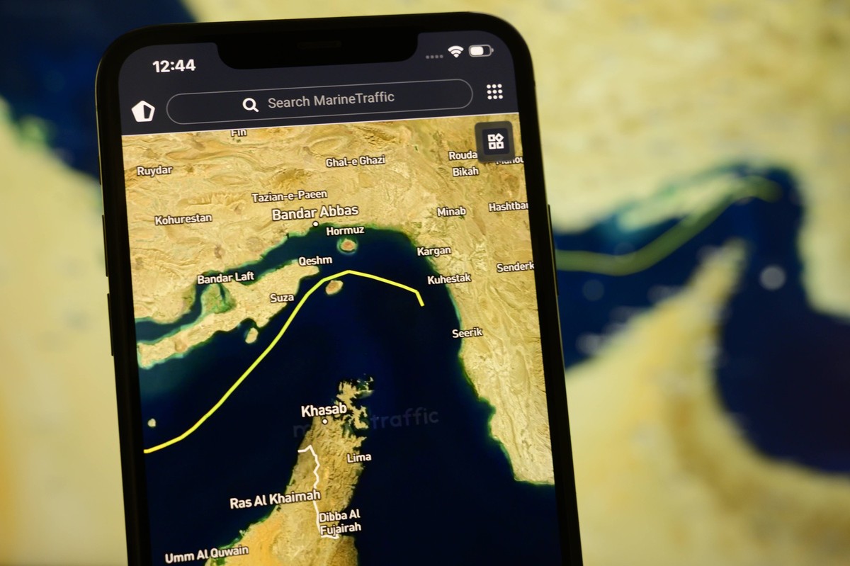 Photo Illustration - Reopening Of Maritime Transport In The Strait Of Hormuz A smartphone displays the MarineTraffic app showing a ship transiting the Strait of Hormuz with a satellite view of the str ...