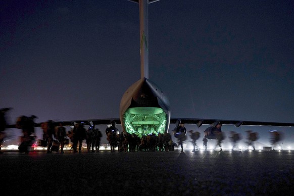 FILE - In this Aug. 30, 2021, file photo provided by the U.S. Air Force, soldiers, assigned to the 82nd Airborne Division, prepare to board a U.S. Air Force C-17 Globemaster III aircraft at Hamid Karz ...