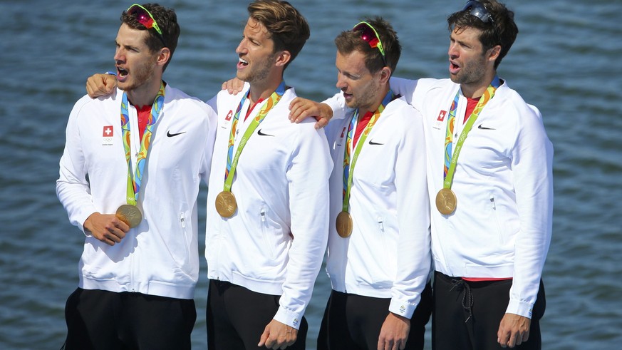 2016 Rio Olympics - Rowing - Victory Ceremony - Lightweight Men&#039;s Four Victory Ceremony - Lagoa Stadium - Rio De Janeiro, Brazil - 11/08/2016. Gold medalists Lucas Tramer (SUI) of Switzerland, Si ...