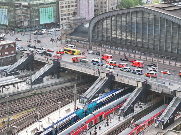 epa12129304 Ambulance and German police gather outside the central station in Hamburg, Germany, 23 May 2025, following a knife attack at the station that left several people wounded, some critically a ...