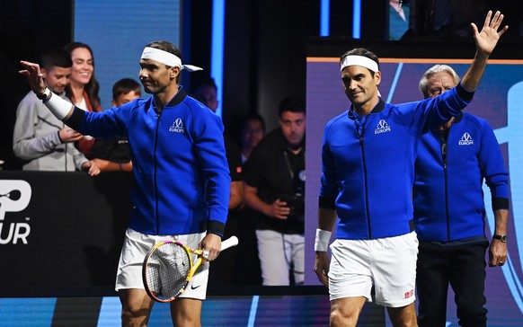 epa10202592 Team Europe double Roger Federer (R) of Switzerland and Rafael Nadal of Spain enter the courr for their match against Team World double Jack Sock of the US and Frances Tiafoe of the US on  ...