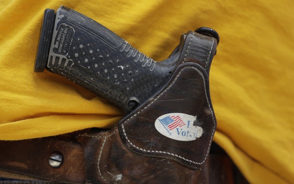 A man wears an unloaded pistol during a pro gun-rights rally at the state capitol, Saturday, April 14, 2018, in Austin, Texas. Gun rights supporters rallied across the United States to counter a recen ...