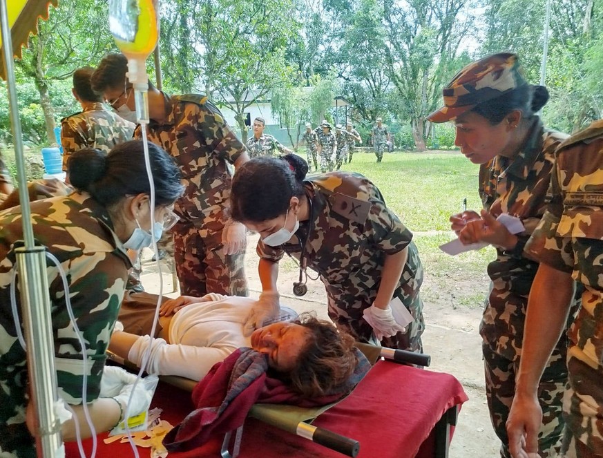 RECORD DATE NOT STATED Nepal Army conducts rescue operations following flash flood Nepal, Aug 26 ANI: Nepal Army personnel treat an injured in the flash flood caused by an outburst in the Bhotekoshi R ...
