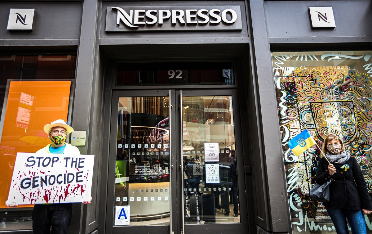 April 10, 2022, New York, New York, USA: Protesters gathered outside of Nespresso on Prince street in SOHO Manhattan in rally against the war in Ukraine. Nestle Group, which owns Nespresso as well as  ...