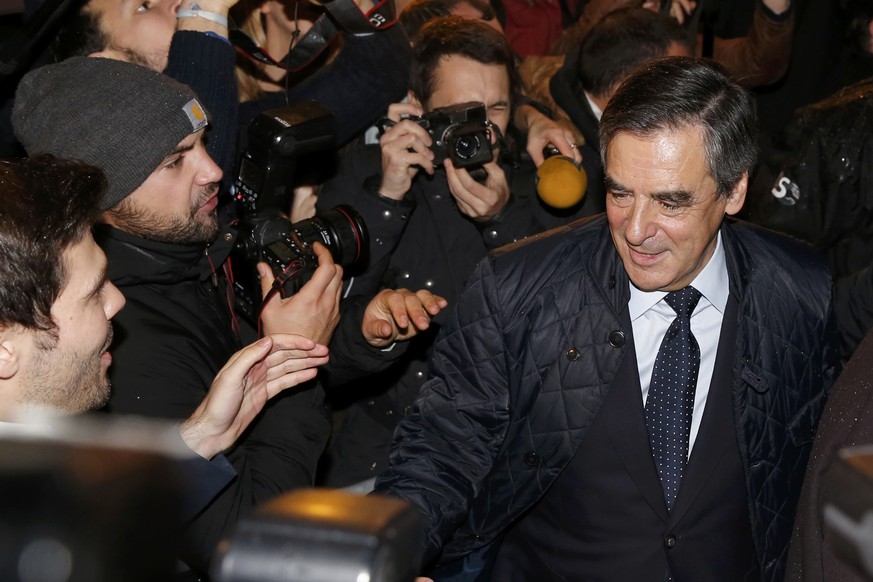 French politician Francois Fillon (R), member of the conservative Les Republicains political party, arrives after partial results in the first round of the French center-right presidential primary ele ...