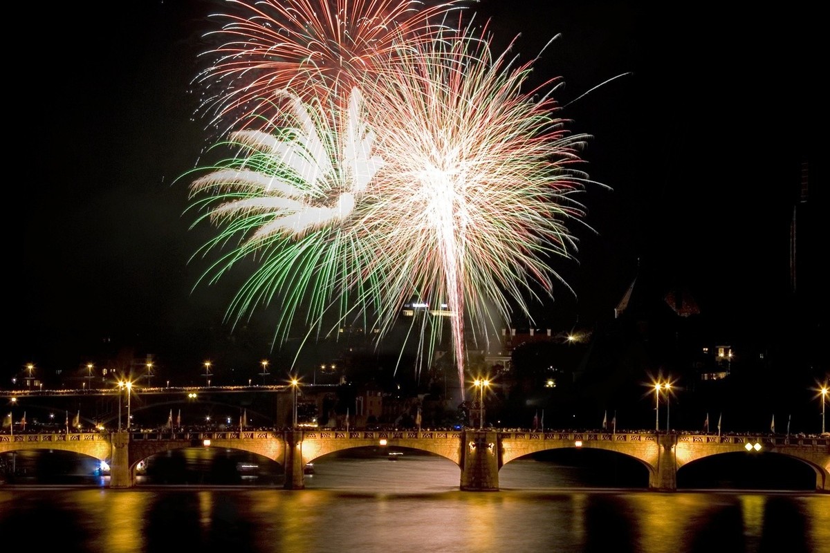 Fireworks explode above the river Rhine in Basel, Switzerland, on Tuesday July 31, 2007. The city of Basel celebrated Switzerland's National Day, which is officially on August 1, one day ahead. ( ...