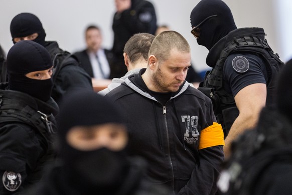 epa08346370 (FILE) - Suspect Miroslav Marcek (C) arrives at the opening of the main trial concerning the murder of journalist Jan Kuciak and his fiancee Martina Kusnirova, in the Judicial Academy buil ...