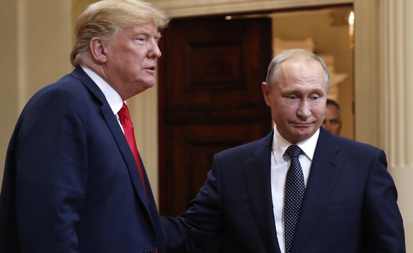 U.S. President Donald Trump, left, and Russian President Vladimir Putin leave a press conference after their meeting at the Presidential Palace in Helsinki, Finland, Monday, July 16, 2018. (AP Photo/P ...