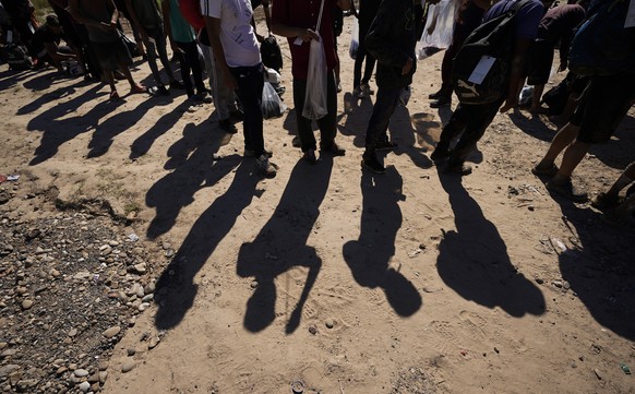 FILE – Migrants await processing by U.S. Customs and Border Patrol after crossing the Rio Grande and entering the U.S. from Mexico.  August 19, 2023, in Eagle Pass, Texas.  The Ministry of Justice...