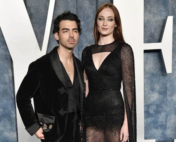 FILE – Joe Jonas, left, and Sophie Turner appear at the Vanity Fair Oscar Party on March 12, 2023 at the Wallis Annenberg Center in Beverly Hills, California.  Jonas filed for divorce from Turner after…