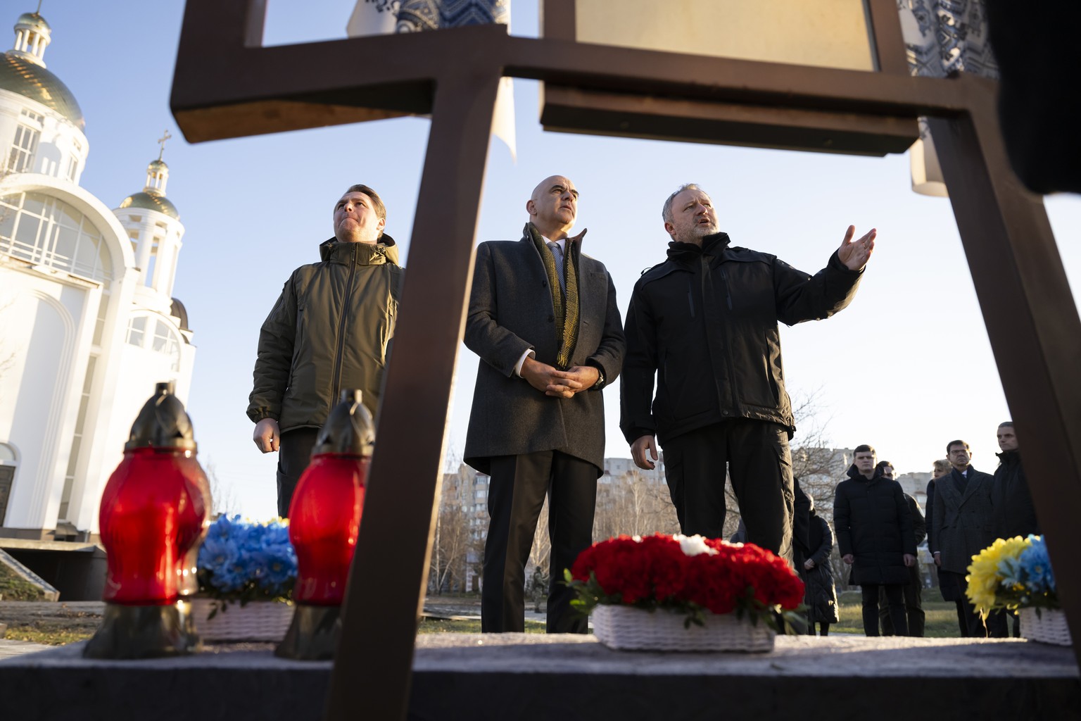 Andriy Kostin, General Prosecutor, right, speaks to Alain Berset, President of the Swiss Confederation, center, next to Ruslan Kravchenko, Mayor of Bucha, left, during a commemoration ceremony at the  ...