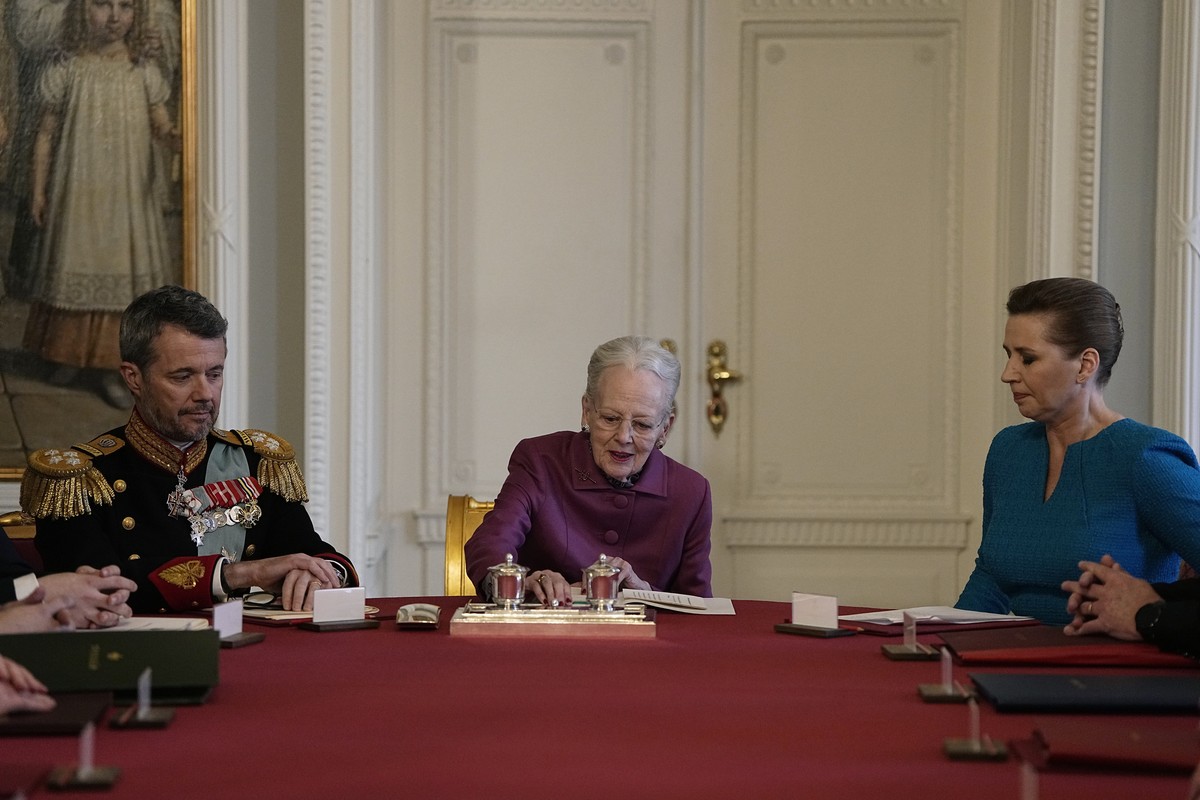 Denmark's Queen Margrethe II, centre, signs a declaration of abdication in the meeting of the Council of State at Christiansborg Castle in Copenhagen, Sunday, Jan. 14, 2024. Queen Margrethe II ha ...