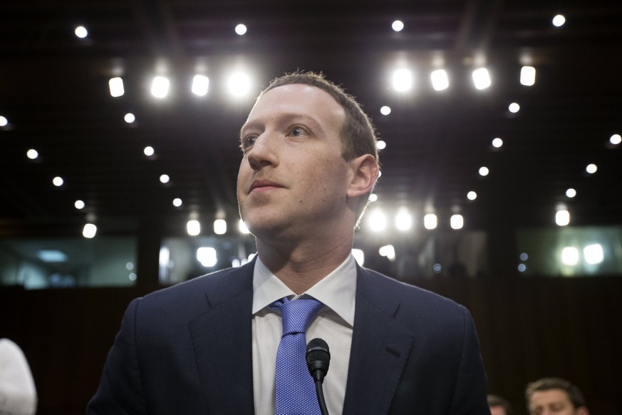 epa06660554 CEO of Facebook Mark Zuckerberg (C) takes his seat following a break in testifying before the Senate Commerce, Science and Transportation Committee and the Senate Judiciary Committee joint ...