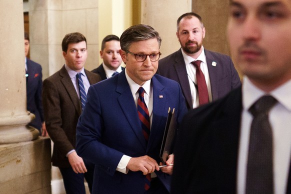 epa11786521 US House Speaker Mike Johnson (C) leaves his office at the US Capitol, in Washington, DC, USA, 19 December 2024. House Republican leadership negotiated a new budget supplemental following  ...