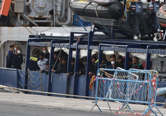 epa10289910 Migrants look on from the ship Humanity 1 of the SOS Humanity NGO docked at the port of Catania, Sicily, Italy, 06 November 2022. The ship carrying 179 migrants who were rescued at sea was ...