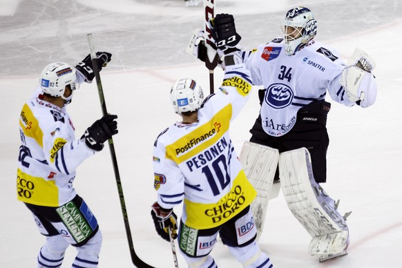 Ambri-Piotta&#039;s goaltender Gauthier Descloux, right, celebrates with teammates defender Michael Ngoy, left, and Ambri-Piotta&#039;s forward Janne Pesonen, of Finland, center, after winning the sho ...
