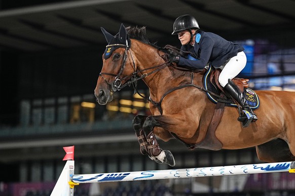 epa09403397 Malin Baryard-Johnsson of Sweden on Indiana competes in the Jumping team final during the Equestrian events of the Tokyo 2020 Olympic Games at the Baji Koen Equestrian Park in Setagaya, To ...