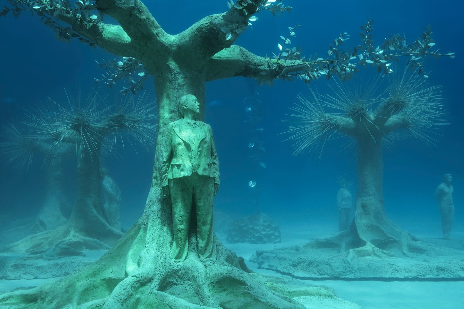 Children playing hide and seek underwater sculpture
