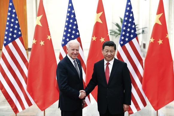 Chinese President Xi Jinping, right, shakes hands with U.S Vice President Joe Biden, left, as they pose for photos at the Great Hall of the People in Beijing, China, Wednesday, Dec. 4, 2013. (AP Photo ...