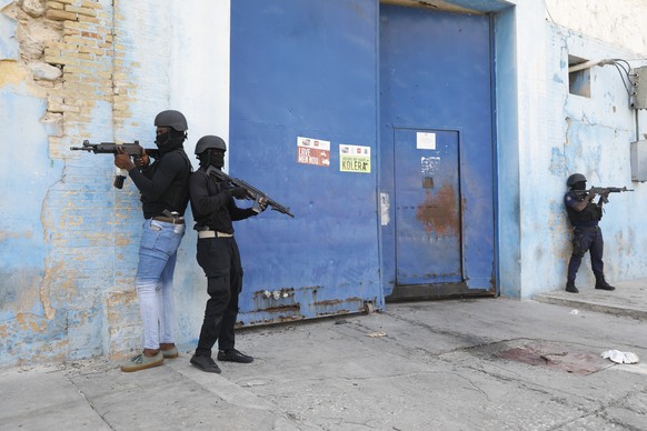National Police stand guard outside the empty National Penitentiary after a small fire inside downtown Port-au-Prince, Haiti, Haiti, Thursday, March 14, 2024. This is the same facility that held armed…
