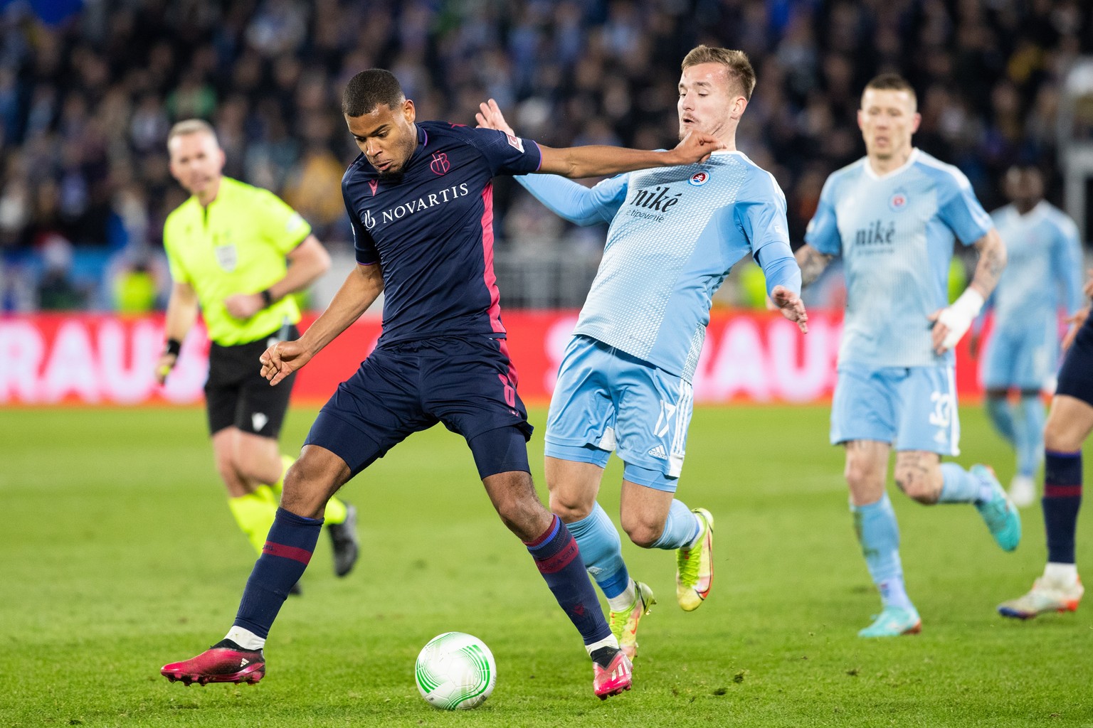 epa10527170 Bratislava&#039;s Jurij Medvedev (R) in action against Basel&#039;s Andy Diouf (L) during the UEFA Conference League round of 16 second leg soccer match between SK Slovan Bratislava and FC ...
