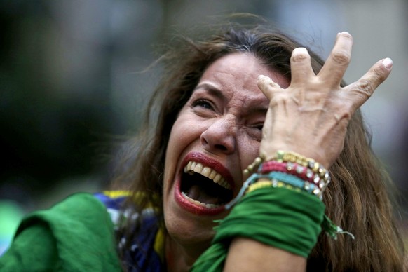 A Brazil soccer fan cries as Germany scores against her team at a semifinal World Cup match as she watches the game on a live telecast in Belo Horizonte, Brazil, Tuesday, July 8, 2014. (AP Photo/Bruno ...