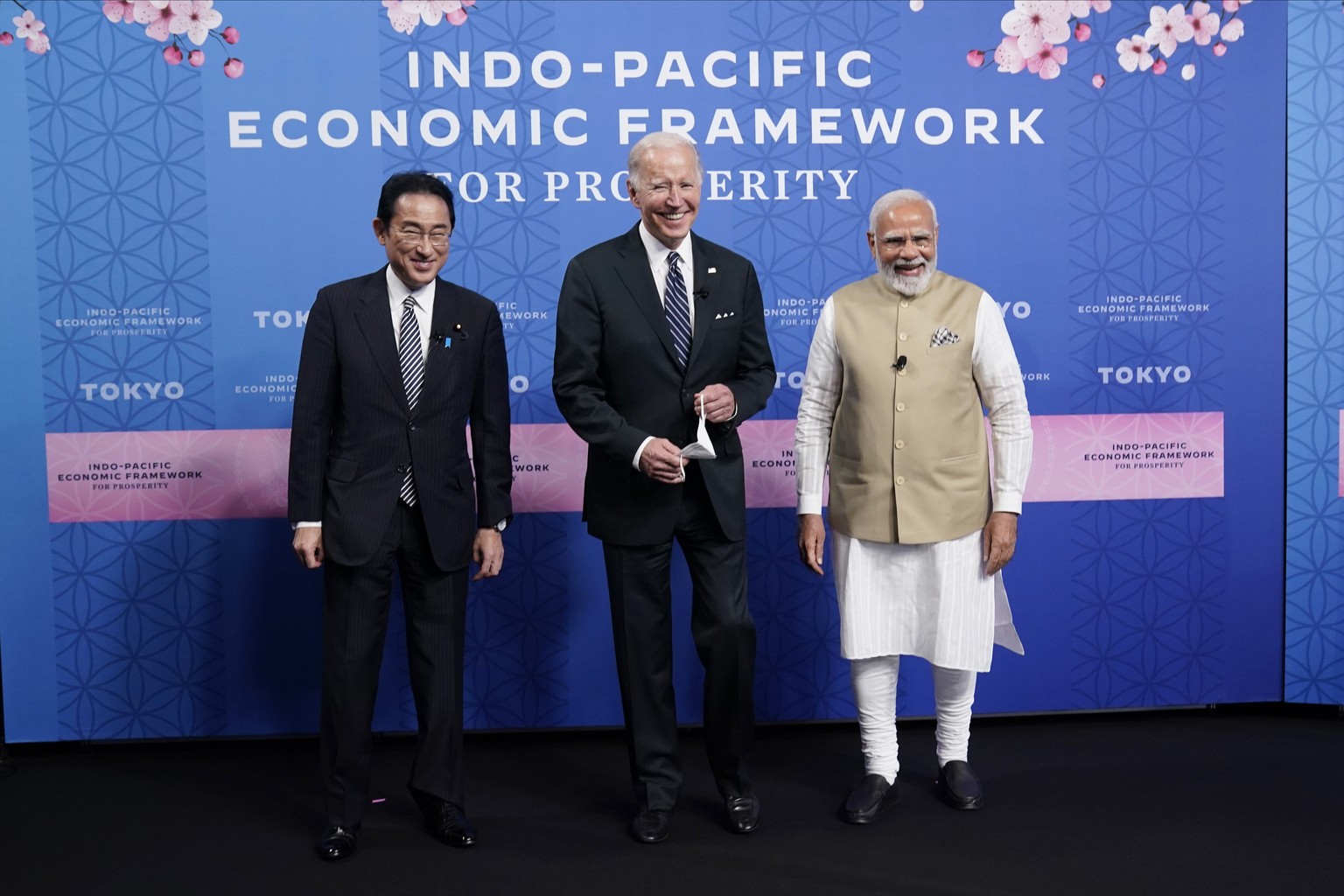 Japanese Prime Minister Fumio Kishida, left, President Joe Biden and Indian Prime Minister Narendra Modi pose for photos as they arrive at the Indo-Pacific Economic Framework for Prosperity launch eve ...