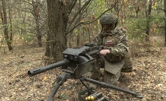 epa11622265 A still image taken from a handout video made available by the Russian Defence Ministry Press-Service on 24 September 2024 shows a Russian marine examines the US MK-19 belt-fed automatic m ...