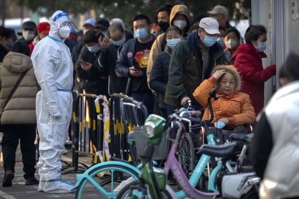 People wearing face masks wait for COVID-19 tests at a coronavirus testing site in Beijing, Thursday, Nov. 17, 2022. Chinese authorities faced more public anger Thursday after a second child&#039;s de ...