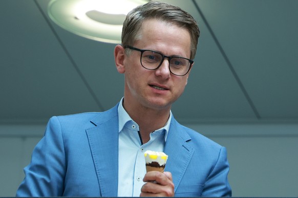 epa11579747 Christian Democratic Union (CDU) party secretary general, Carsten Linnemann, holds an ice cream prior to a press conference at the Christian Democrats headquarters, Konrad-Adenauer-Haus, i ...