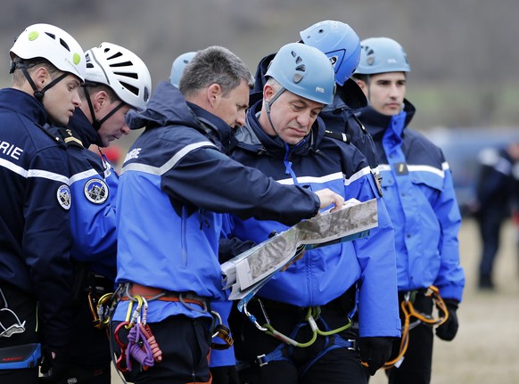 epa04677552 Members of the French Gendarmerie talk about operations in Seyne les Alpes, southeastern France, 24 March 2015, near the crash site of the Germanwings Airbus A320 in the French Alps. Germa ...