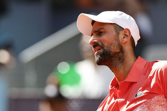 epa12056862 Novak Djokovic of Serbia looks on as he plays against Matteo Arnaldi of Italy during their second round match at the Madrid Open tennnis tournament in Madrid, Spain, 26 April 2025. EPA/Che ...