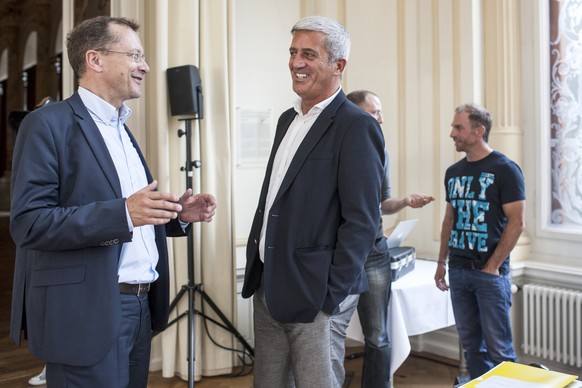 Vladimir Petkovic, coach of the Swiss soccer team, centre, speaks to Marco von Ah, head of communication, left, during a press conference on Thursday, July 31 2014, in Lucerne, Switzerland. (KEYSTONE/ ...