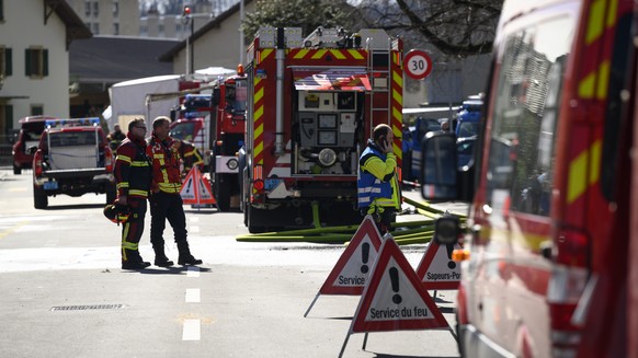 Firefighters on the street close to a villa where bodies were found after a fire, in Yverdon-les-bains, Switzerland, Thursday, March 9, 2023. An explosion followed by a fire took place Thursday mornin ...