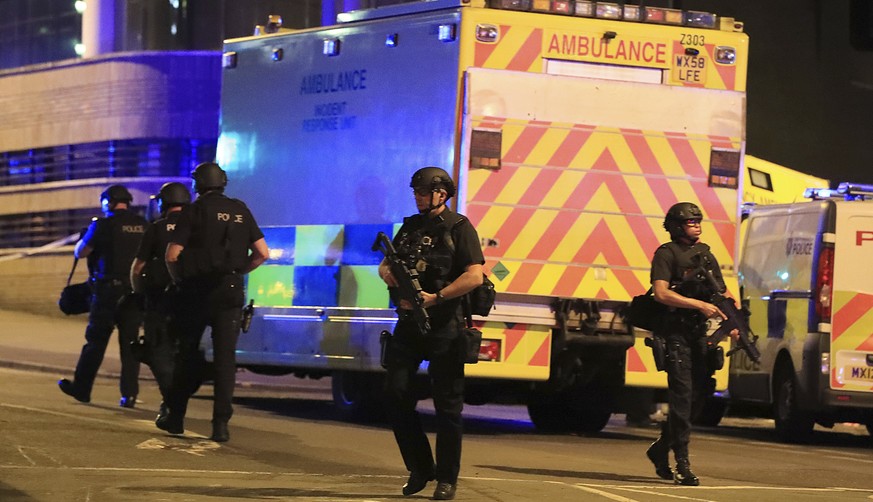 Armed police work at Manchester Arena after reports of an explosion at the venue during an Ariana Grande gig in Manchester, England Monday, May 22, 2017. Several people have died following reports of  ...