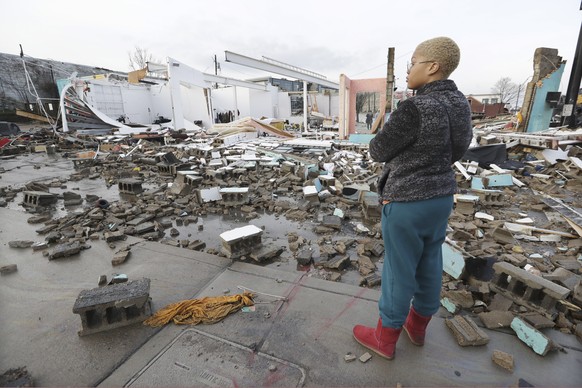 FILE �?? In this March 3, 2020, file photo, Faith Patton looks over buildings destroyed by storms in Nashville, Tenn. It has been nearly a year since deadly tornados tore across Nashville and other pa ...