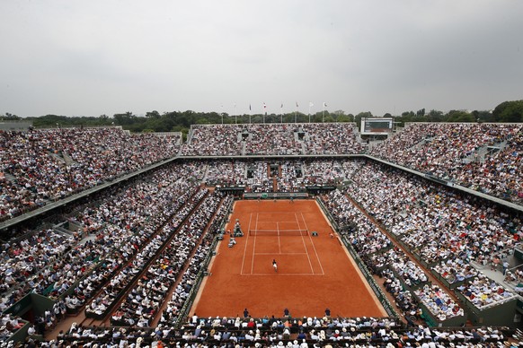 FILE - In this June 10, 2018 file photo, the crowd watch Austria&#039;s Dominic Thiem serving to Spain&#039;s Rafael Nadal during the men&#039;s final match of the French Open tennis tournament at the ...