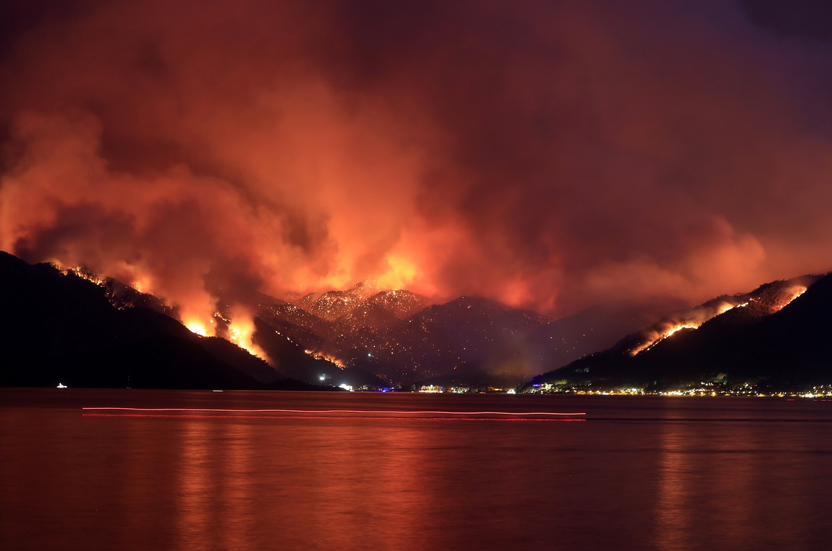 epa09379600 Smoke rises from a forest fire in Mugla's Marmaris district in Turkey, 29 July 2021 (issued 30 July 2021). The Turkish government's Disaster and Emergency Management Presidency ( ...