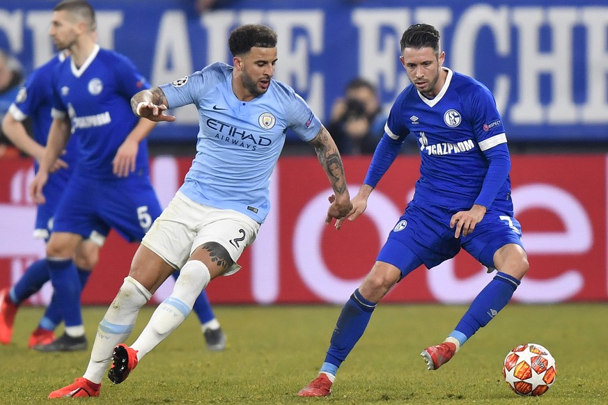 Manchester City defender Kyle Walker, left, fights for the ball with Schalke forward Mark Uth during the first leg, round of sixteen, Champions League soccer match between Schalke 04 and Manchester Ci ...