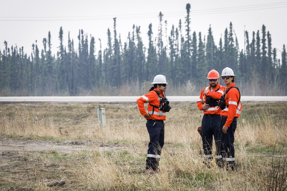 Wildfire specialists with Fire &amp; Flood Emergency Service Ltd., pictured along highway 881 near Georgoire Lake Estates southeast of Fort McMurray, Alberta, Wednesday, May 15, 2024. (Jeff McIntosh/T ...
