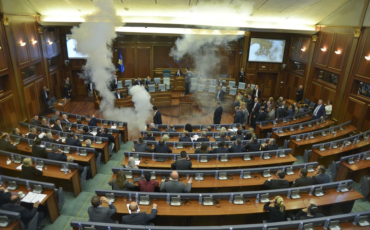 Opposition lawmakers in Kosovo disrupt Parliament's session using tear gas and whistles, in capital Pristina on Thursday, Oct. 8, 2015,. The opposition protested over the government's recent ...