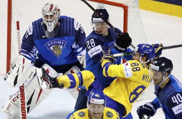 Sweden&#039;s William Nylander, 2nd right, clashes with Finland&#039;s Henri Jokiharju during the Ice Hockey World Championships quarterfinal match between Finland and Sweden at the Steel Arena in Kos ...