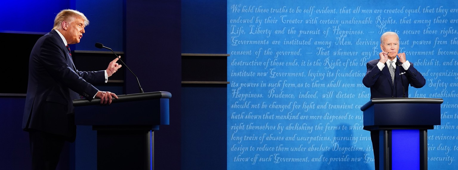 epa08707233 US President Donald J. Trump (L) and Democratic presidential candidate Joe Biden (R) participate in the first 2020 presidential election debate at Samson Pavilion in Cleveland, Ohio, USA,  ...